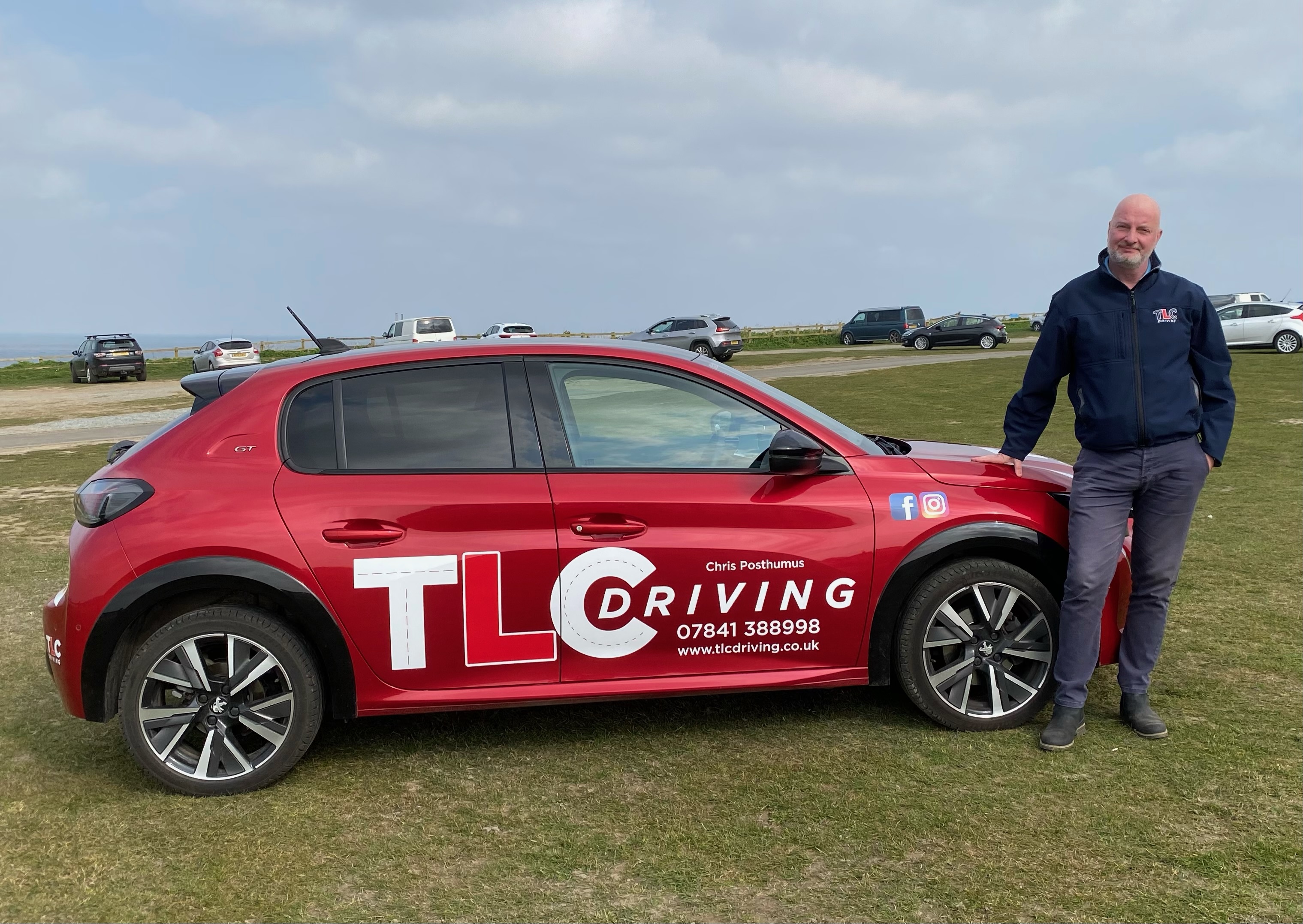 Chris Posthumus stood next to his car